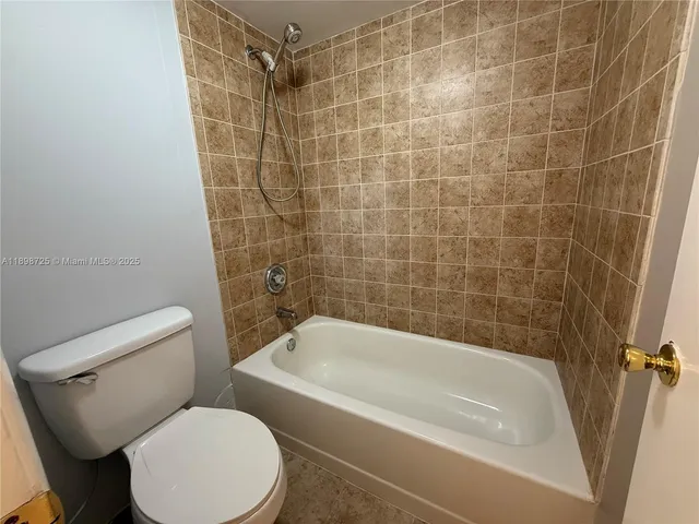 a white bath tub sitting next to a white toilet