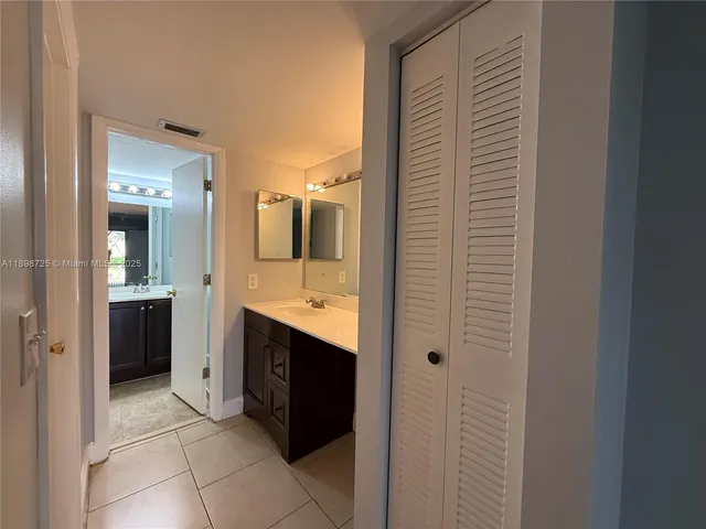 a view of bathroom with a sink and mirror