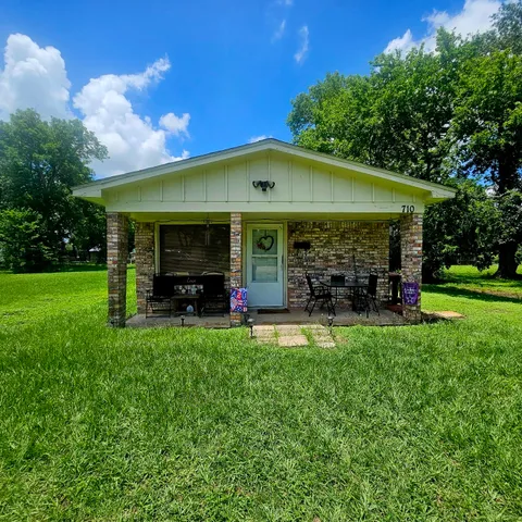 a view of a house with backyard porch and sitting area