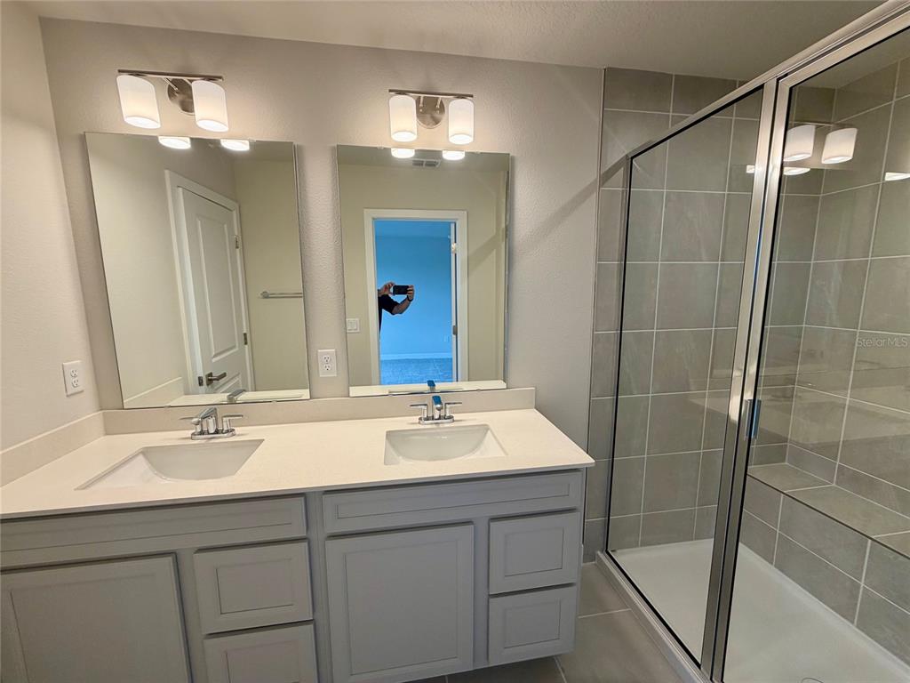 602 Highfalls Avenue DeBary, FL 32713 - Photo 18 of 29 a bathroom with a sink tub double vanity and a mirror