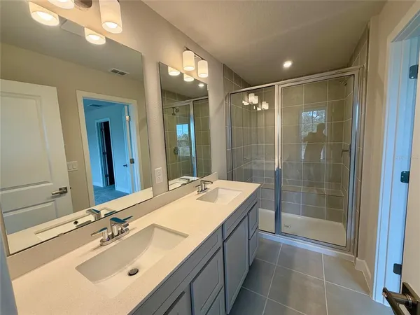 a bathroom with a sink double vanity and a mirror