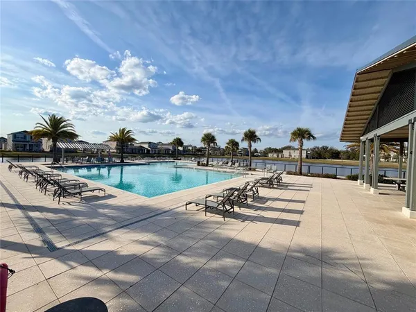 a view of a swimming pool and lounge chairs