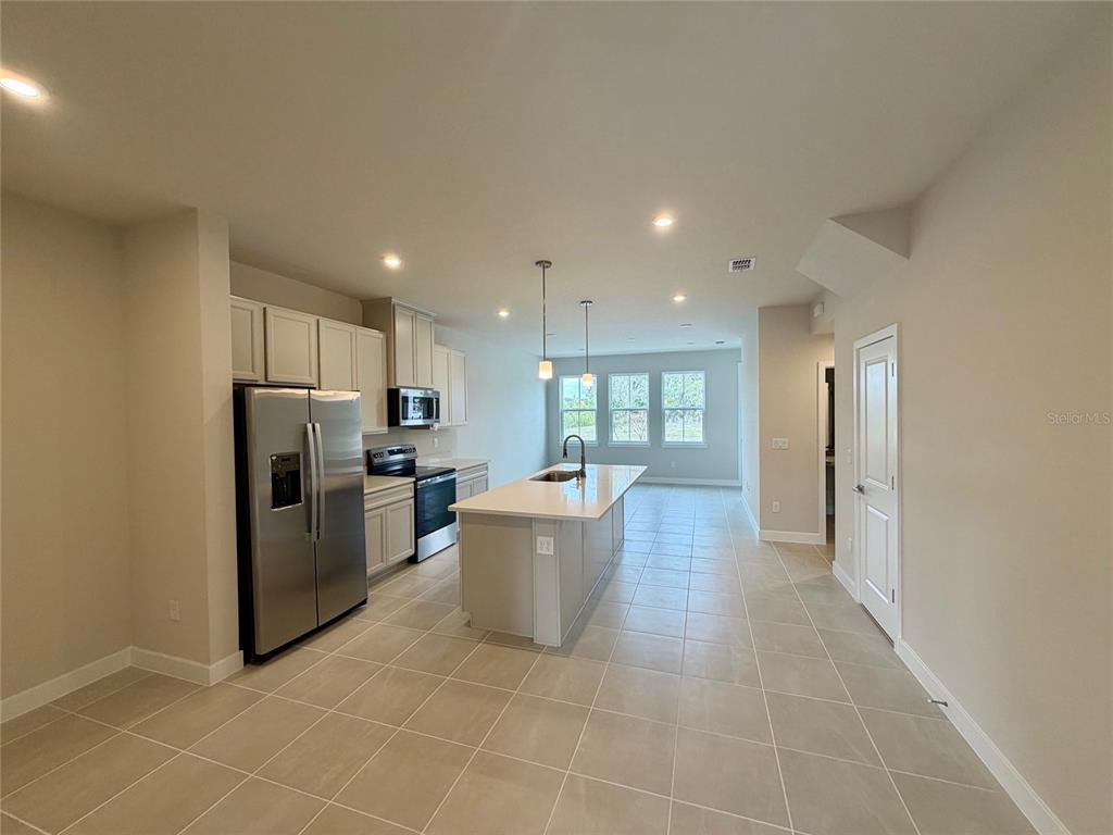 602 Highfalls Avenue DeBary, FL 32713 - Photo 4 of 29 a kitchen with a refrigerator and a sink