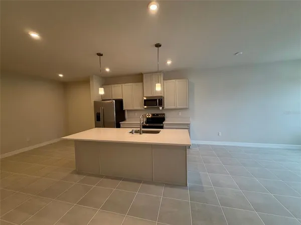 a view of kitchen with stainless steel appliances a sink and a counter top