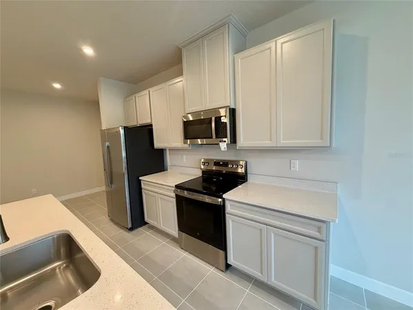 a kitchen with a sink stove and refrigerator