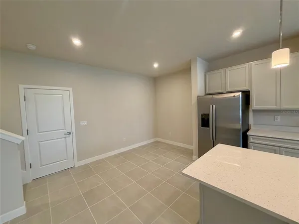 a kitchen with stainless steel appliances a refrigerator sink and microwave