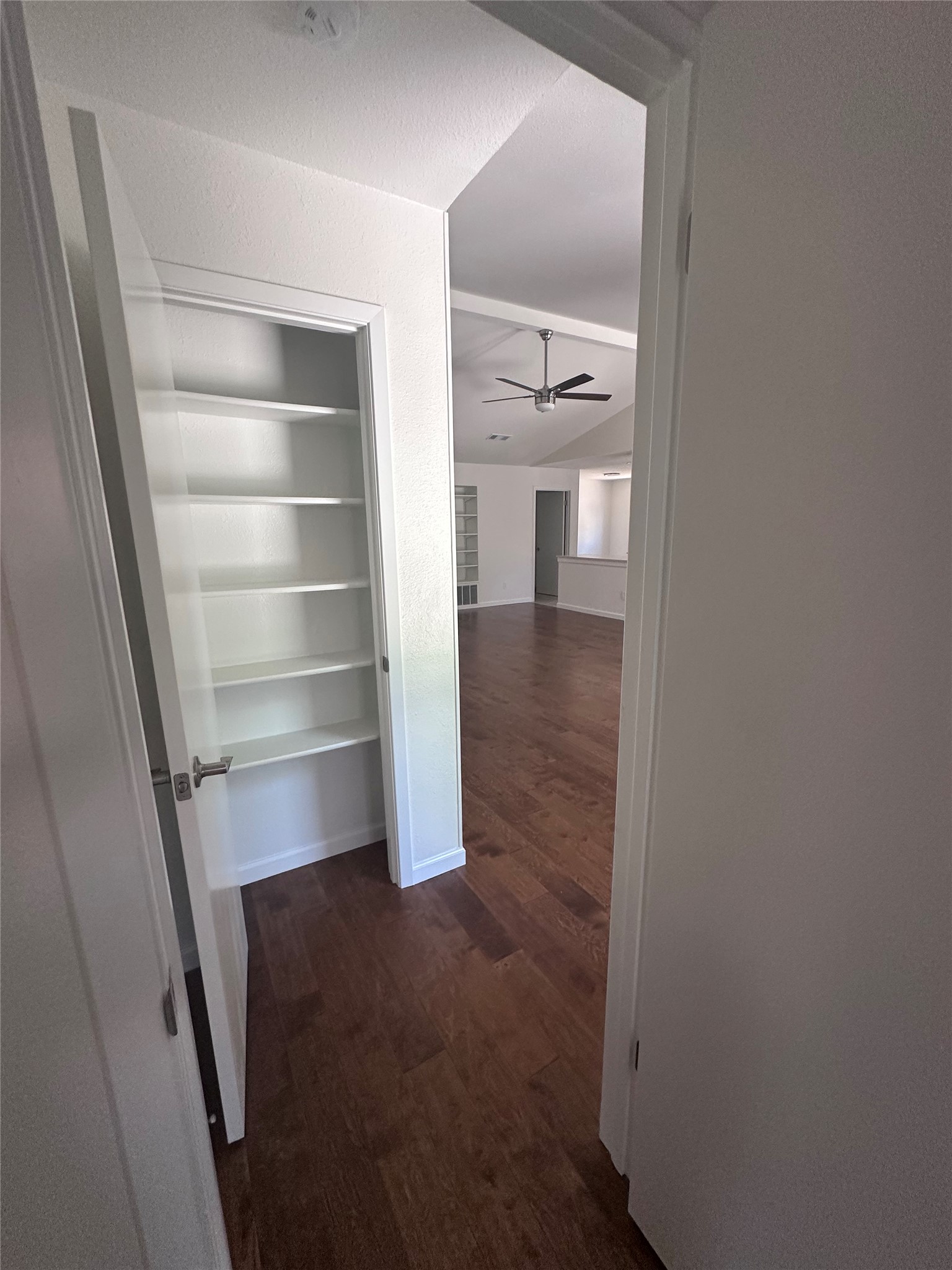 12610 Andromeda Cove Austin, TX 78727 - Photo 17 of 29 Rich wood flooring connects a built-in storage closet to the spacious open living area.