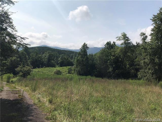 999 Holbert Cove Road Saluda, NC 28773 - Photo 14 of 14 a view of a green field with wooden fence