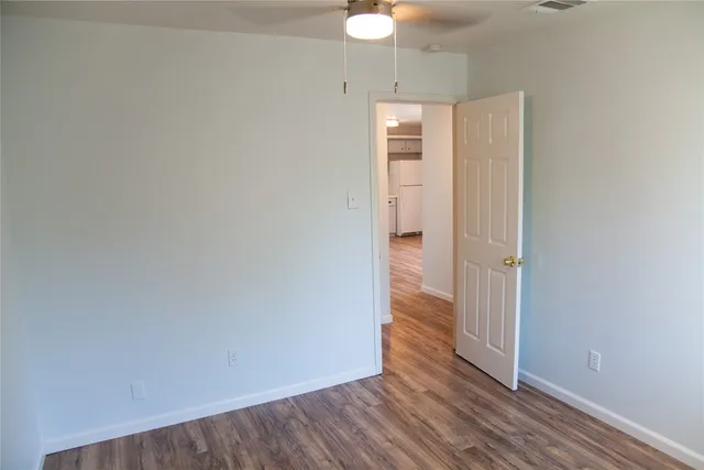 an empty room with wooden floor