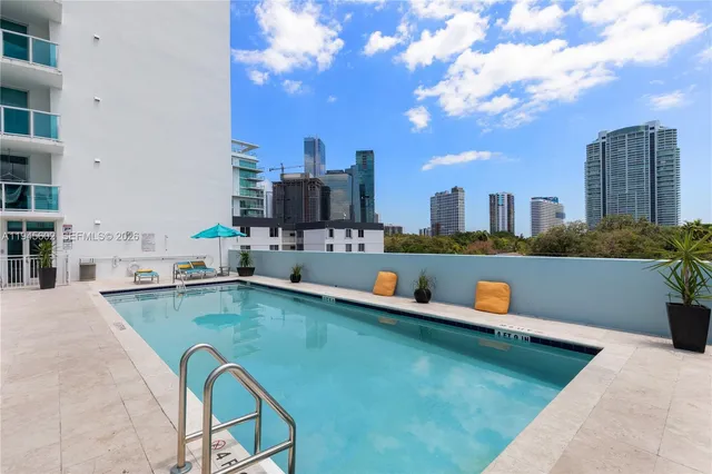 a swimming pool with outdoor seating and yard