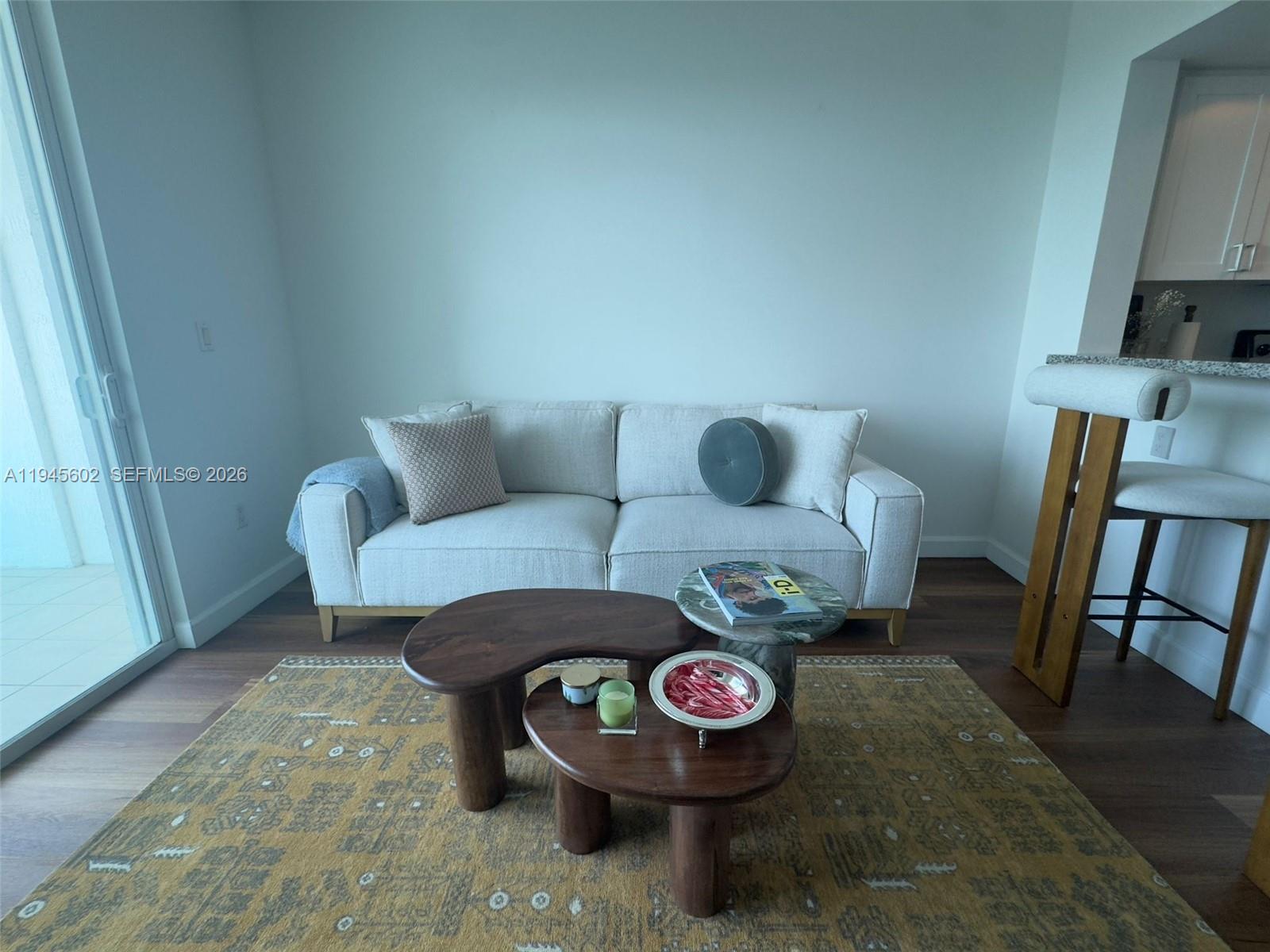 1723 Southwest 2nd Avenue, Unit 1104 Miami, FL 33129 - Photo 2 of 15 a living room with furniture and a wooden floor