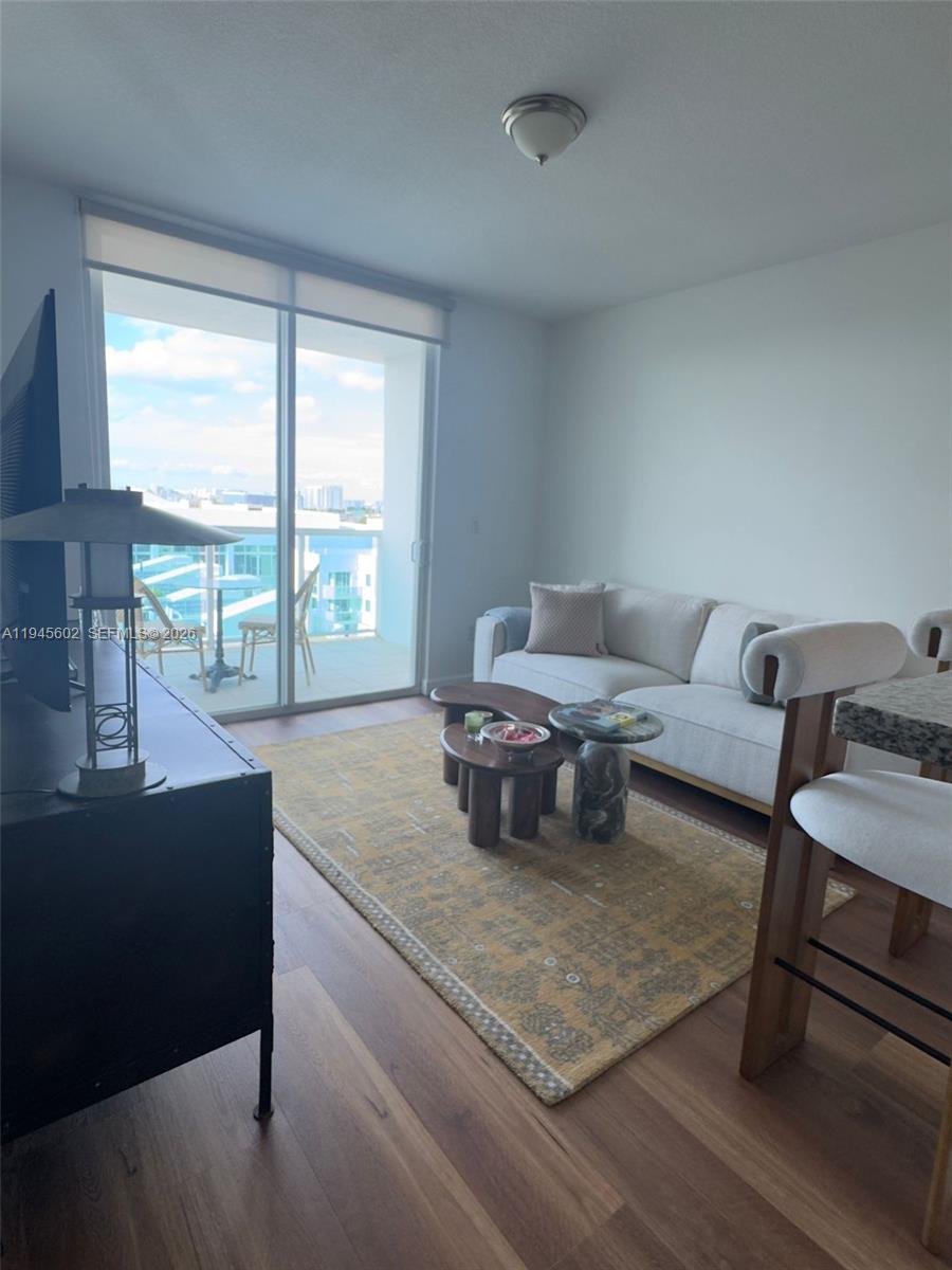 1723 Southwest 2nd Avenue, Unit 1104 Miami, FL 33129 - Photo 4 of 15 a living room with furniture and a floor to ceiling window