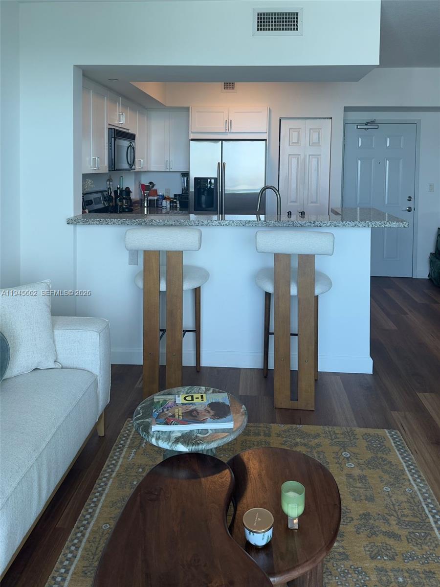 1723 Southwest 2nd Avenue, Unit 1104 Miami, FL 33129 - Photo 5 of 15 a kitchen with a table and chairs in it