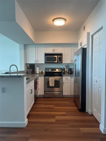 a kitchen with stainless steel appliances granite countertop a stove and a refrigerator