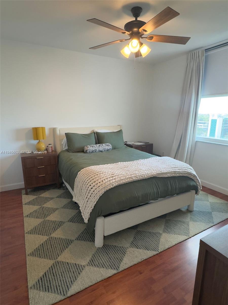 1723 Southwest 2nd Avenue, Unit 1104 Miami, FL 33129 - Photo 7 of 15 a bedroom with a bed and a chandelier