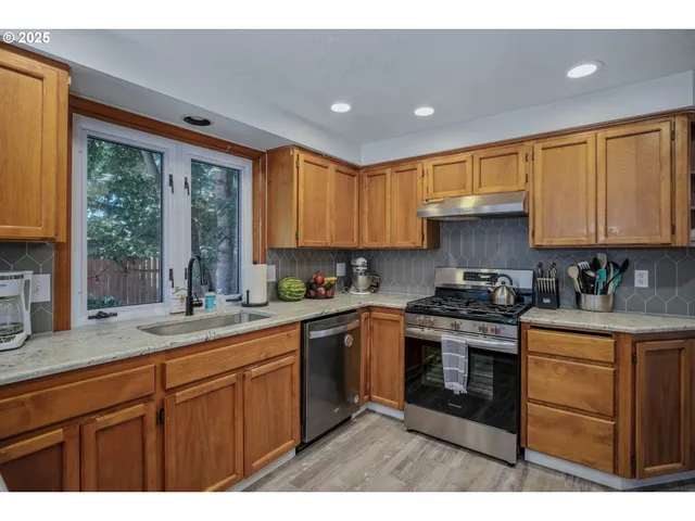 a kitchen with a sink stove and cabinets