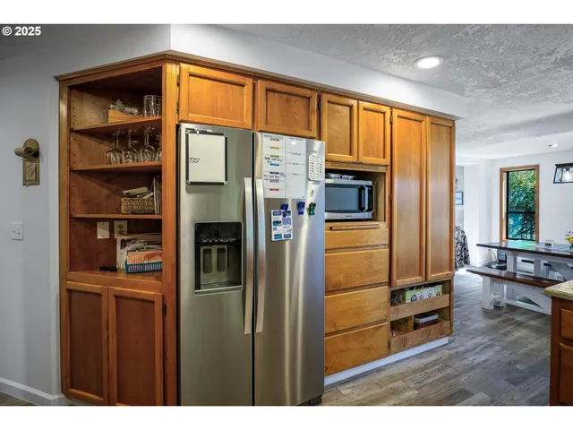 a kitchen with stainless steel appliances granite countertop a refrigerator and a sink