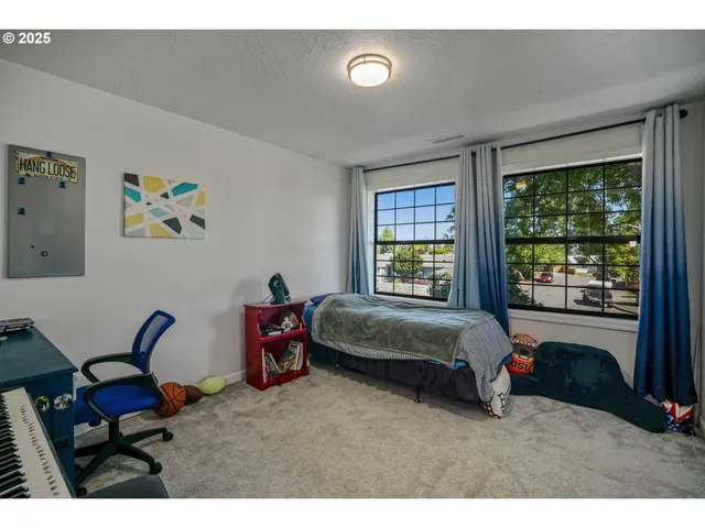 a bed sitting in a bedroom next to a window