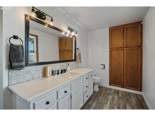 a bathroom with a sink a mirror and a shower