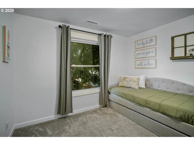 a living room with furniture and a bed