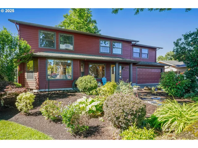 a view of a house with potted plants and a tree