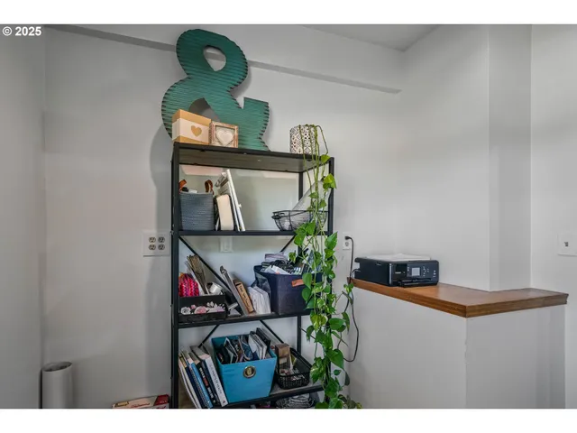 a patio with table and chairs with potted plants