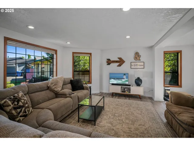 a living room with furniture and a large window