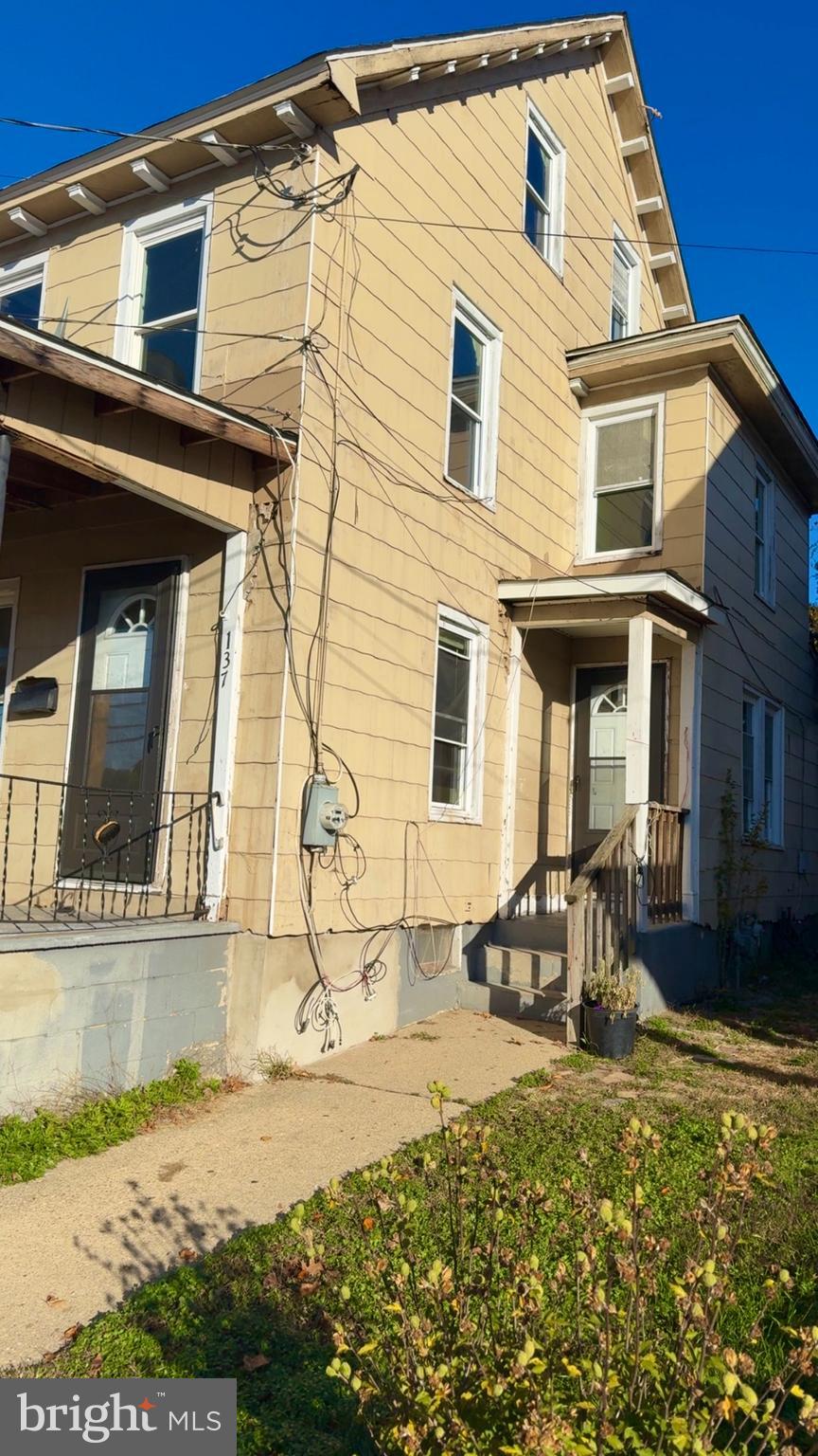137 Penn Street Bridgeton, NJ 08302 - Photo 2 of 2 front view of a house with a yard