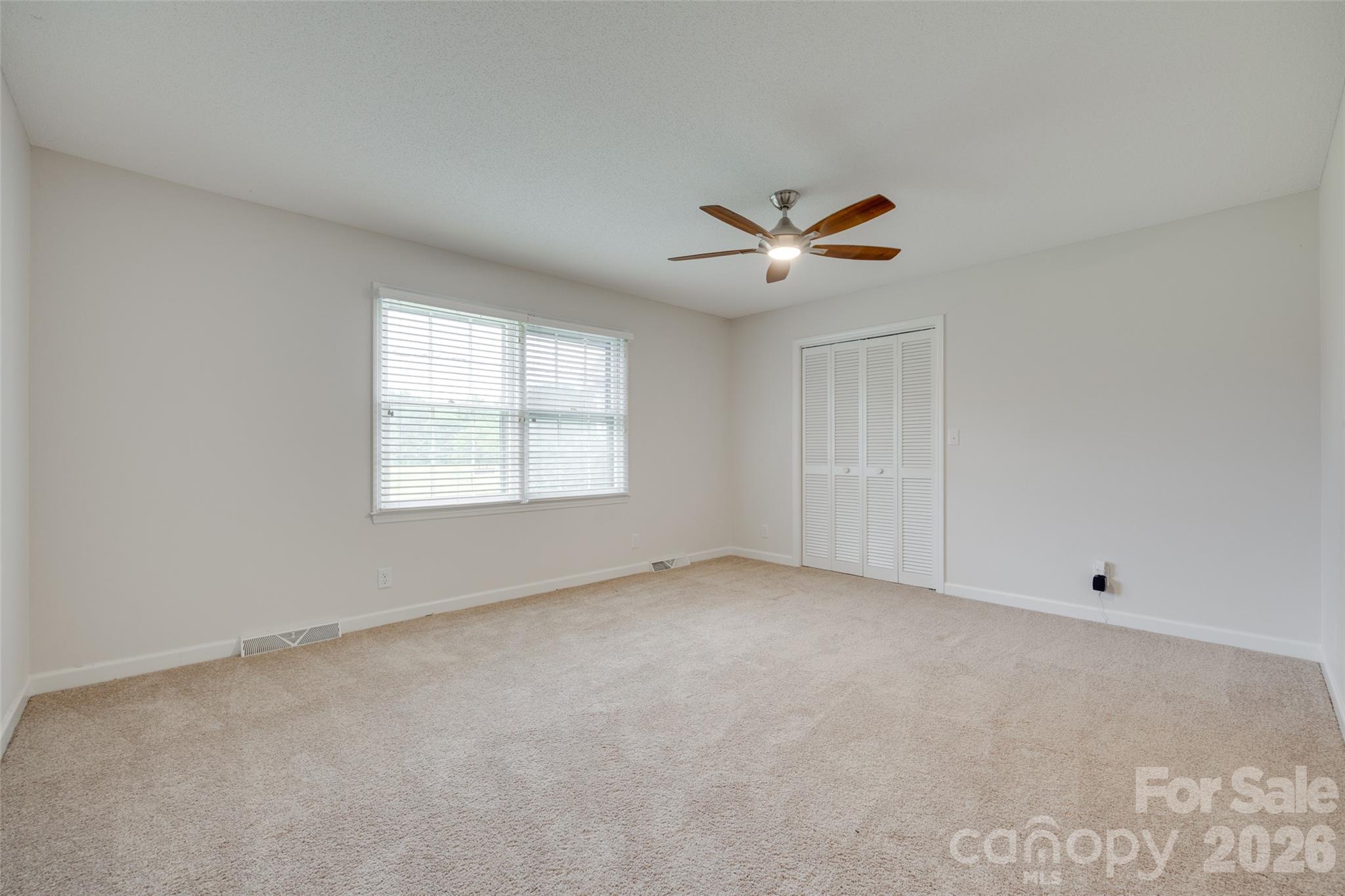 1003 Chesterfield Avenue Lancaster, SC 29720 - Photo 17 of 31 an empty room with windows and ceiling fan