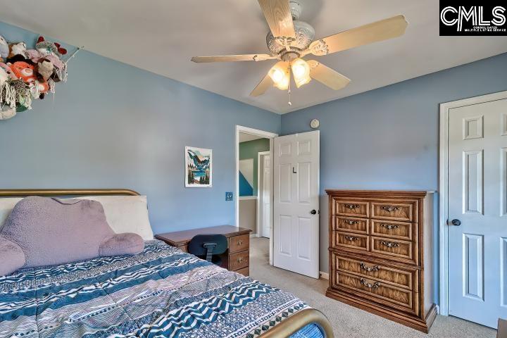 209 Eagle Pointe Drive Chapin, SC 29036 - Photo 29 of 40 a bedroom with a bed and a chandelier