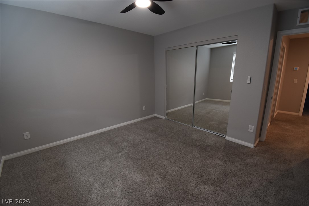 12107 Azure Gate Road, Unit 4 Las Vegas, NV 89183 - Photo 8 of 19 3rd Bedroom with fan and closet with mirror doors