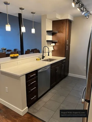 a kitchen with a sink appliances and cabinets