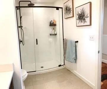 a bathroom with a shower and a glass door