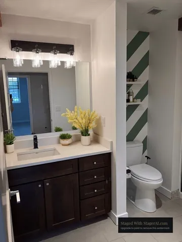 a bathroom with a double vanity sink mirror and toilet