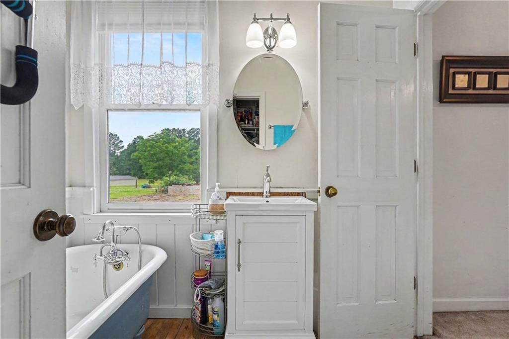 355 Inman Road Hampton, GA 30228 - Photo 31 of 47 a bathroom with a tub sink and mirror