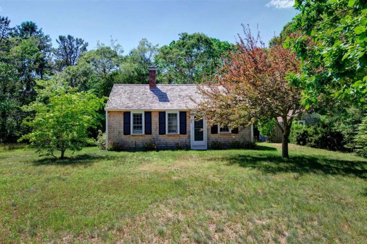 55 Little River Road Cotuit, MA 02635 - Photo 1 of 1 a front view of a house with a garden