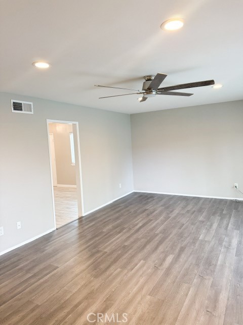 7414 Blackhawk Circle Buena Park, CA 90620 - Photo 2 of 15 a view of an empty room with wooden floor and a ceiling fan