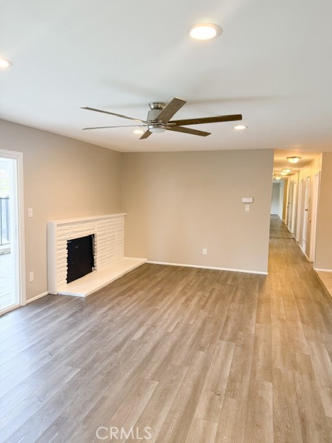 7414 Blackhawk Circle Buena Park, CA 90620 - Photo 3 of 15 a view of an empty room with wooden floor and a fireplace