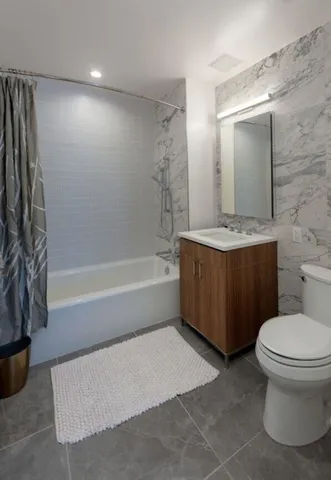 a bathroom with a toilet a sink and bathtub