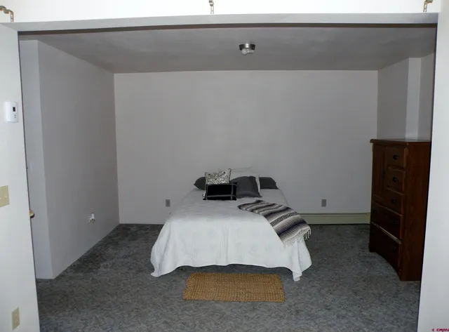 a bedroom with a bed and cabinets