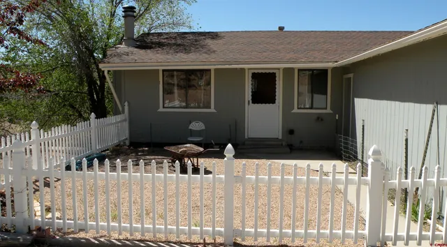 a side view of a house with wooden fence