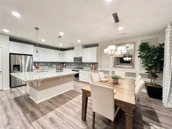 a large kitchen with a table and chairs