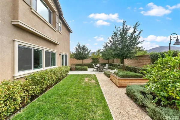 a view of a backyard with sitting area
