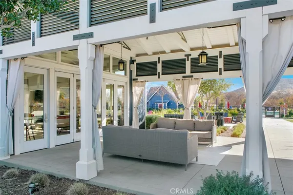 a building outdoor space with patio furniture and potted plants