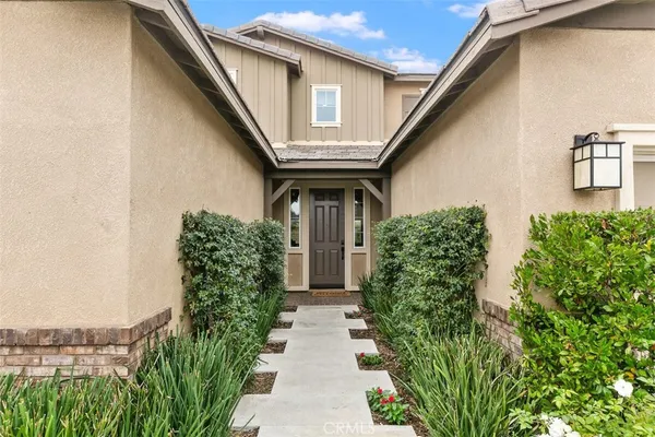 a house with potted plants in front of it
