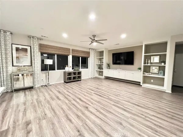 a view of a living room kitchen and a flat screen tv