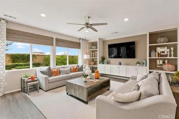 a living room with furniture large window and a flat screen tv