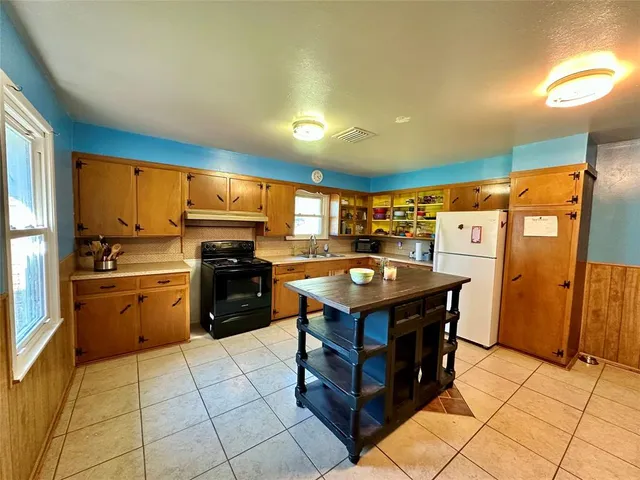 a kitchen with a refrigerator and a sink