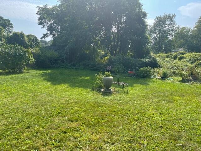 90 West Tisbury Road Edgartown, MA 02539 - Photo 15 of 46 a backyard of a house with lots of green space and fountain