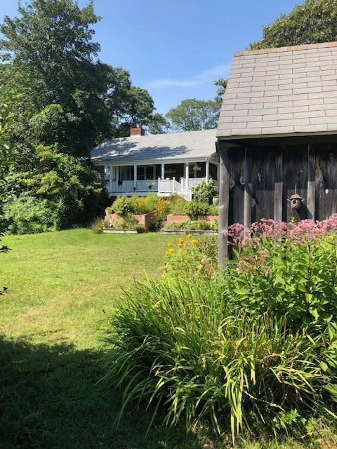 90 West Tisbury Road Edgartown, MA 02539 - Photo 18 of 46 a front view of a house with garden